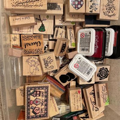 Many wood stamps in clear plastic tote