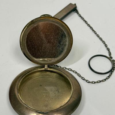 Sale Photo Thumbnail #17: Snap-open lid reveals a mirror inside the lid and a chamber for holding makeup powder. Attached rectangular tube likely held a pencil. Weight is 50.6g. Great condition, no dings or damage.