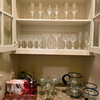 Sale Photo Thumbnail #36: Lot of glassware: 12 wine, 5 gold rim, 4 Martini, 4 large silver rim,  4 small silver rim, 4 champagne,  Mexican glass blue rim pitcher with 2 matching margarita glasses, 3 green stem margarita glasses, 4 Lingchamp wine in box,  3 small green stem.