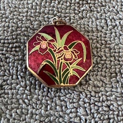 Beautiful octagonal pendant featuring a vibrant red enamel background with a floral design,