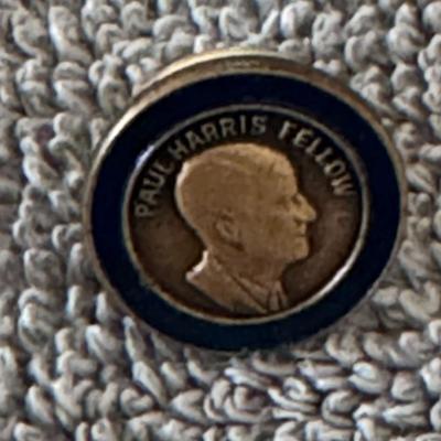 Paul Harris Fellow pin, a recognition awarded by Rotary International.