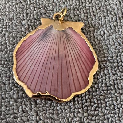 Seashell pendant with a gold trim