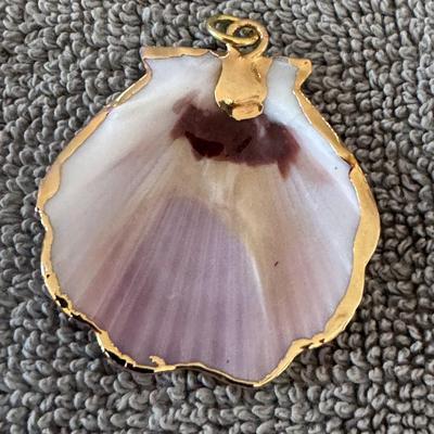 Seashell pendant with a gold trim