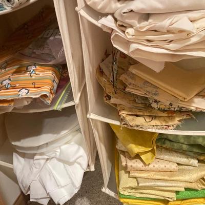 2 hanging organizers with many pieces of fabric