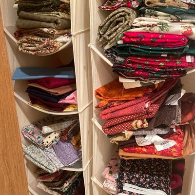 2 hanging organizers with many pieces of fabric