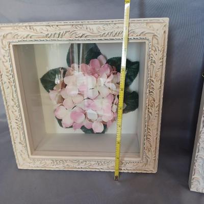 Sale Photo Thumbnail #145: 2-shadow box picture frames with flowers inside. One is white and the other 
is off-white.