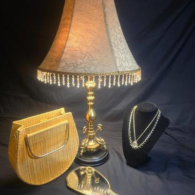 BRASS BASE DOUBLE LIGHTED LAMP, VANITY MIRROR, 2 NECKLACES AND A PURSE