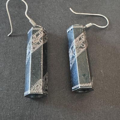 Elegant black rectangular dangle earrings with intricate silver-colored filigree or engraved designs.