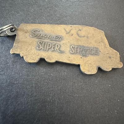Snap-on Tools truck-shaped keychain, made of solid brass.