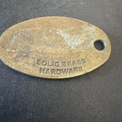 Vintage Izod Lacoste metal tag, used as a charm, jacket pull or keychain accessory.