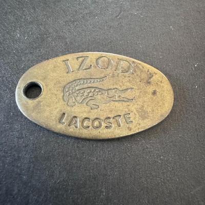 Vintage Izod Lacoste metal tag, used as a charm, jacket pull or keychain accessory.