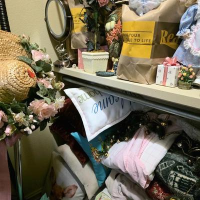 Sale Photo Thumbnail #64: Closet full of miscellaneous items including decor, florals, linens including a blue and yellow quilted daybed comforter set.