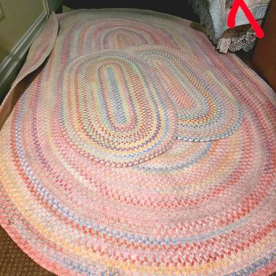 Sale Photo Thumbnail #66: 3 braided pastel oval rugs, the largest measuring 95.5"L x 58"W. The other 2 measuring the standard 2x3 door mat size. And 3 decorative wall hangings.