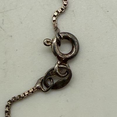 Sale Photo Thumbnail #164: 24" necklace chain. Cameo pendant opens to reveal 2 spaces for small oval photos. Oval stone looks to be made of onyx.