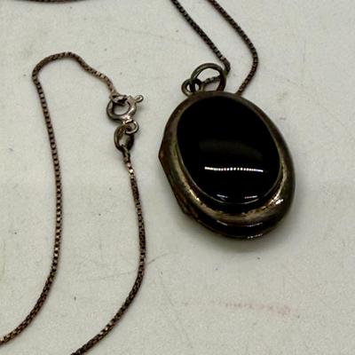 Sale Photo Thumbnail #167: 24" necklace chain. Cameo pendant opens to reveal 2 spaces for small oval photos. Oval stone looks to be made of onyx.