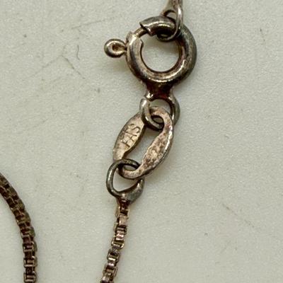 Sale Photo Thumbnail #166: 24" necklace chain. Cameo pendant opens to reveal 2 spaces for small oval photos. Oval stone looks to be made of onyx.