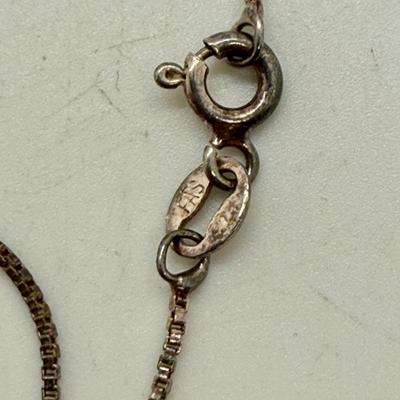 Sale Photo Thumbnail #165: 24" necklace chain. Cameo pendant opens to reveal 2 spaces for small oval photos. Oval stone looks to be made of onyx.