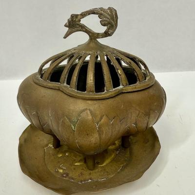 Sale Photo Thumbnail #33: 4-footed brass incense burner base with slotted one-piece lid.  Tray has a relief design of a French man wearing a beret and smoking a pipe. Both in good condition.