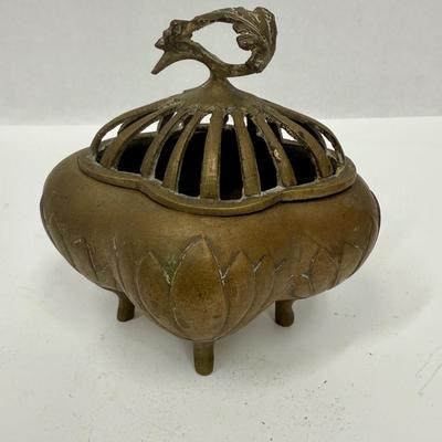 Sale Photo Thumbnail #31: 4-footed brass incense burner base with slotted one-piece lid.  Tray has a relief design of a French man wearing a beret and smoking a pipe. Both in good condition.