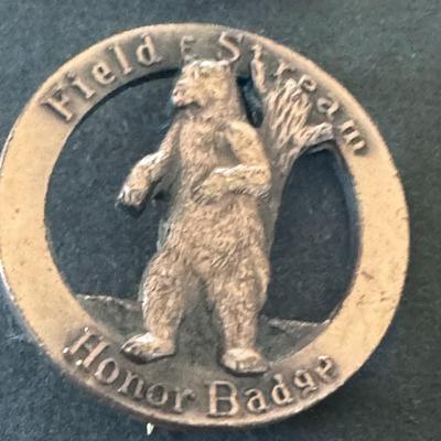 Field & Stream Honor Badges, one featuring a deer and the other a bear.