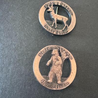 Field & Stream Honor Badges, one featuring a deer and the other a bear.