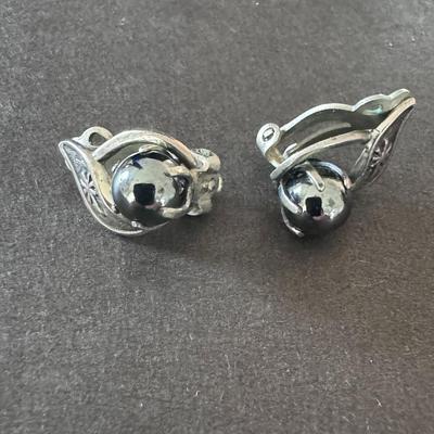 Vintage silver-tone clip-on earrings with a gray, spherical stone, likely hematite.