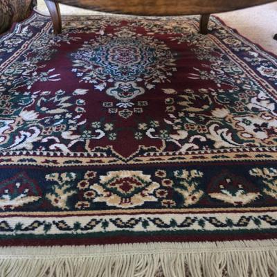 Sale Photo Thumbnail #136: Rectangle wood coffee table with area rug. Please see picture for defect on top of coffee table. Table measures 50"L x 36"W x 17.5"H.
Rug measures 4ft x 5ft.
