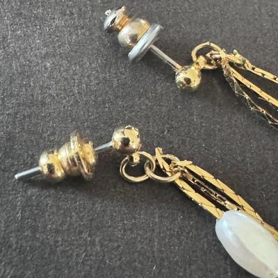 Vintage-style gold-tone dangle earrings with white beaded accents,