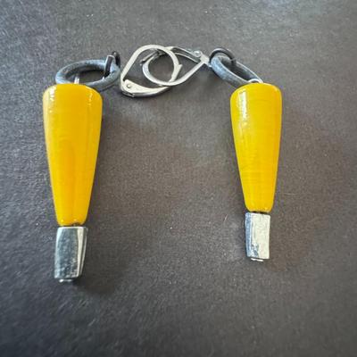 Dangle earrings featuring yellow, conical or teardrop-shaped elements