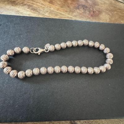Sterling silver bead bracelet, featuring a diamond-cut or textured finish on the beads. Made in Italy