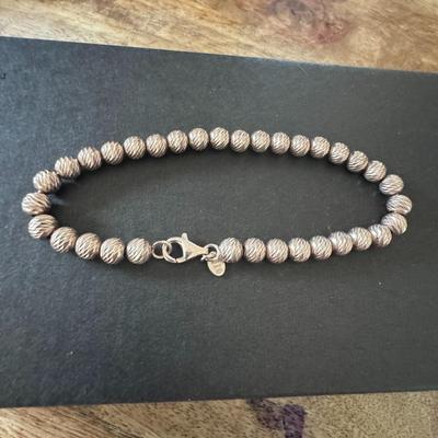 Sterling silver bead bracelet, featuring a diamond-cut or textured finish on the beads. Made in Italy