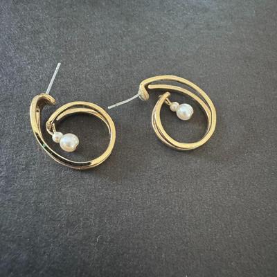 Elegant gold-toned spiral or curled hoop earrings with dangling pearls.