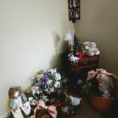 Early American nightstand with miscellaneous decor, florals, baskets and hanging corner wall shelf.