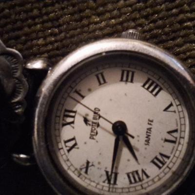 Sale Photo Thumbnail #116: the band is sterling and leather, the watch needs a new battery and is untested.  Not sure if the stones are turquoise or other stone.