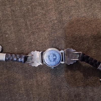 Sale Photo Thumbnail #119: the band is sterling and leather, the watch needs a new battery and is untested.  Not sure if the stones are turquoise or other stone.