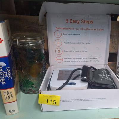 blood pressure monitor, book and jar