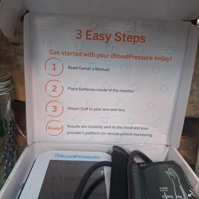 blood pressure monitor, book and jar