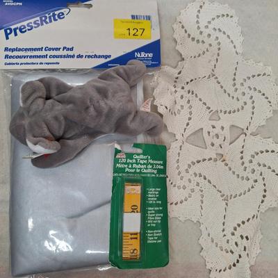 Ironing board cover, beanie and measuring tape