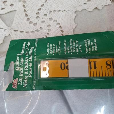 Ironing board cover, beanie and measuring tape