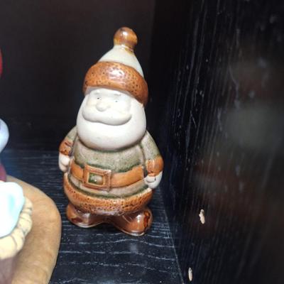 Santa praying over Baby Jesus and other santas