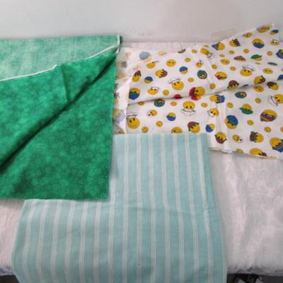 Sale Photo Thumbnail #286: Striped broadcloth fabric is 62" wide, smiley face cotton fabric is 45" wide, shamrock cotton fabric is 45" wide
