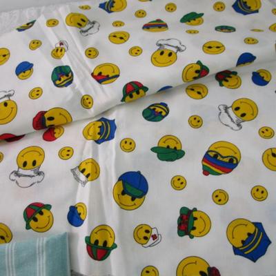 Sale Photo Thumbnail #289: Striped broadcloth fabric is 62" wide, smiley face cotton fabric is 45" wide, shamrock cotton fabric is 45" wide