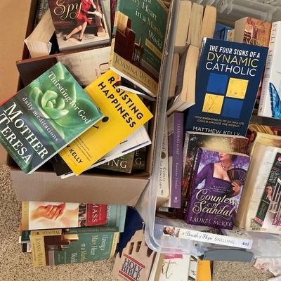 Plastic tote and box full of soft covered books