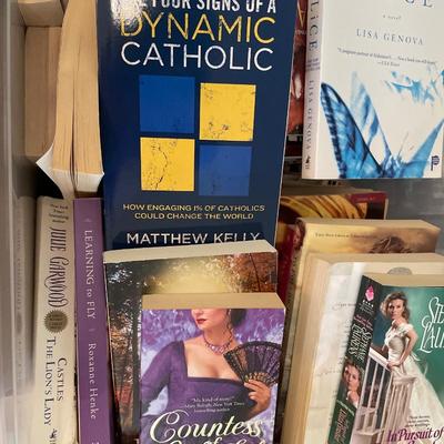 Plastic tote and box full of soft covered books