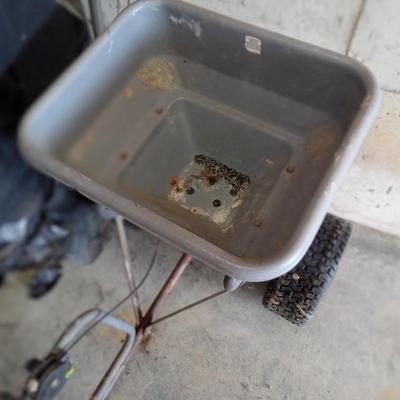 Wheel barrel and lawn seeder