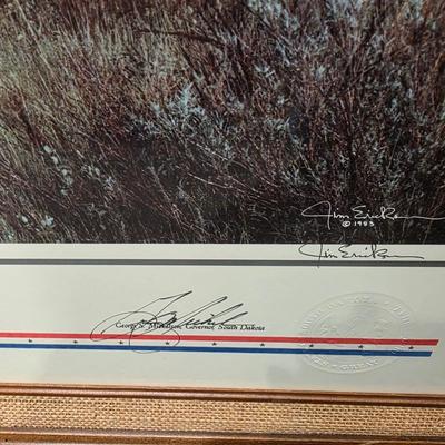 Sale Photo Thumbnail #5: This is a larger print.  Called Land of Dakota is professionally framed, signed and numbered.  Is a great piece of North Dakota history. This celebrates 100 of ND statehood.  Has certificate and information about the piece.  Painted in 1983 this is 57 of 