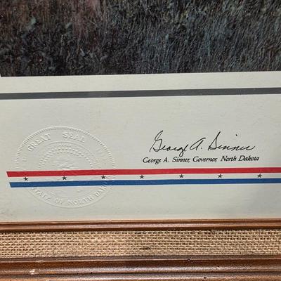 Sale Photo Thumbnail #3: This is a larger print.  Called Land of Dakota is professionally framed, signed and numbered.  Is a great piece of North Dakota history. This celebrates 100 of ND statehood.  Has certificate and information about the piece.  Painted in 1983 this is 57 of 