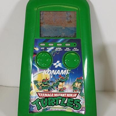 LOT 86: Vintage Teenage Mutant Ninja Turtles Toy Lot Including Pez Dispensers, Handheld Videogame and More