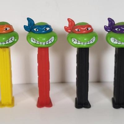 LOT 86: Vintage Teenage Mutant Ninja Turtles Toy Lot Including Pez Dispensers, Handheld Videogame and More