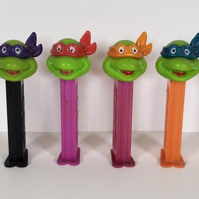 LOT 86: Vintage Teenage Mutant Ninja Turtles Toy Lot Including Pez Dispensers, Handheld Videogame and More